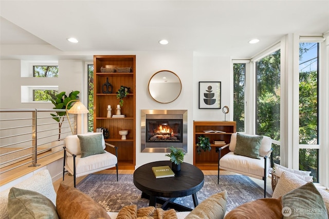 1805 N 36th St, Seattle, WA 98103 - living area featuring wood finished floors, a glass covered fireplace, and recessed lighting