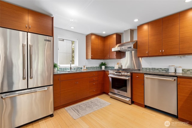 1805 N 36th St, Seattle, WA 98103 - kitchen with appliances with stainless steel finishes, dark countertops, a sink, light wood-style floors, and recessed lighting