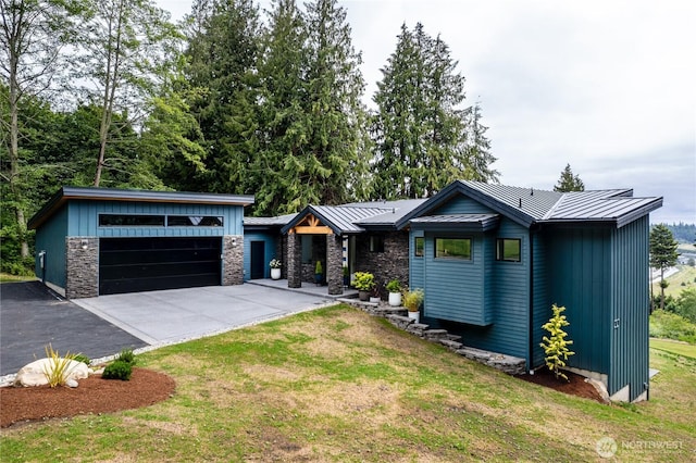 501 Vesper Way, Camano Island, WA 98282 - mid-century modern home featuring a standing seam roof, a front lawn, metal roof, board and batten siding, and stone siding