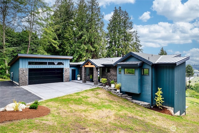 501 Vesper Way, Camano Island, WA 98282 - view of front of property with a standing seam roof, a front lawn, board and batten siding, metal roof, and a garage