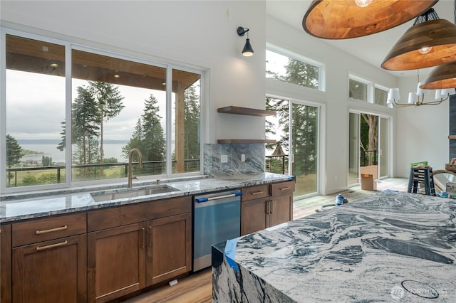 501 Vesper Way, Camano Island, WA 98282 - kitchen with dishwasher, a sink, open shelves, light wood-style floors, and light stone countertops