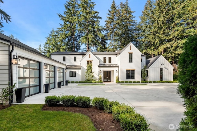 2003 102nd Pl SE, Bellevue, WA 98004 - modern farmhouse style home with french doors, a standing seam roof, driveway, board and batten siding, and metal roof