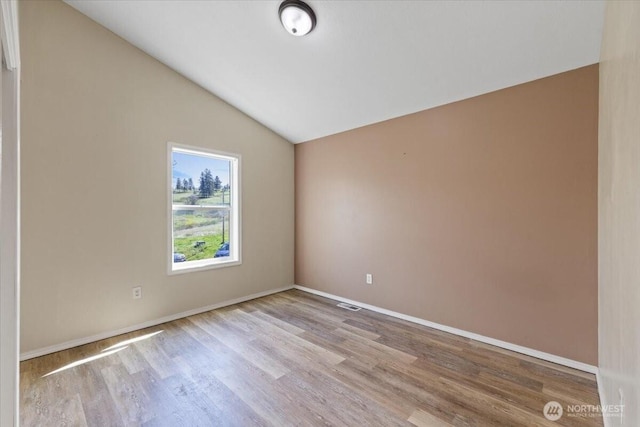42480 N State Route 25, Davenport, WA 99122 - spare room with wood finished floors, vaulted ceiling, and baseboards