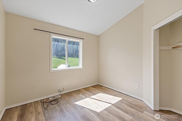 42480 N State Route 25, Davenport, WA 99122 - unfurnished bedroom featuring wood finished floors, baseboards, lofted ceiling, and a closet