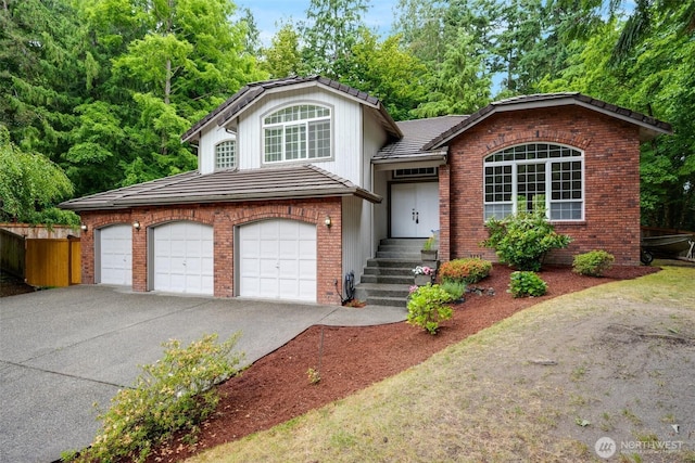 10411 23rd Street Ct E, Edgewood, WA 98372 - split level home with driveway, brick siding, a tile roof, and an attached garage