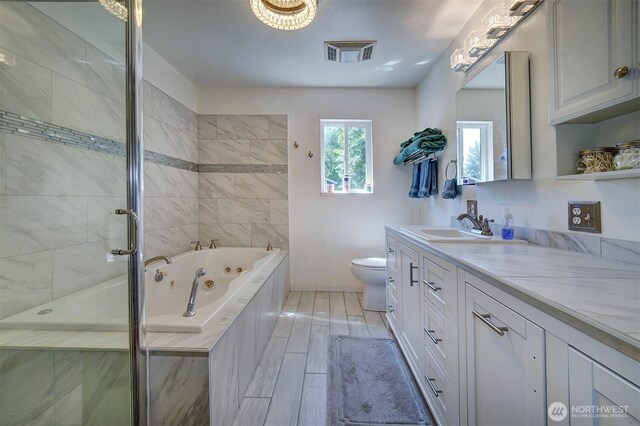 22305 Apollo Dr NE, Poulsbo, WA 98370 - full bathroom featuring vanity, a tub with jets, toilet, a shower with door, and baseboards