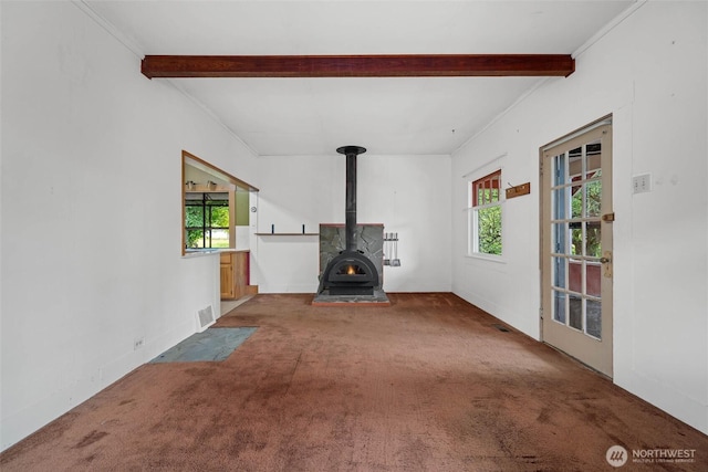 500 Wilson Ave, Bellingham, WA 98225 - unfurnished living room featuring carpet floors, beamed ceiling, and a wood stove