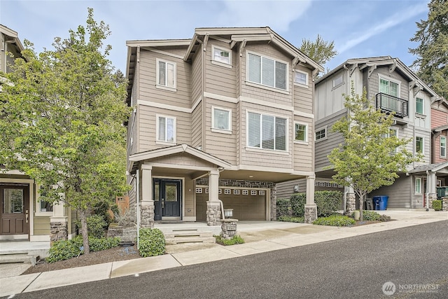 10502 SE 10th Ct Unit 9, Bellevue, WA 98004 - view of property with a garage, concrete driveway, and stone siding