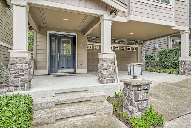 10502 SE 10th Ct Unit 9, Bellevue, WA 98004 - doorway to property with stone siding, a garage, and covered porch