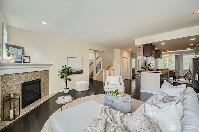 10502 SE 10th Ct Unit 9, Bellevue, WA 98004 - living room featuring dark wood-style flooring, stairs, recessed lighting, a fireplace, and baseboards