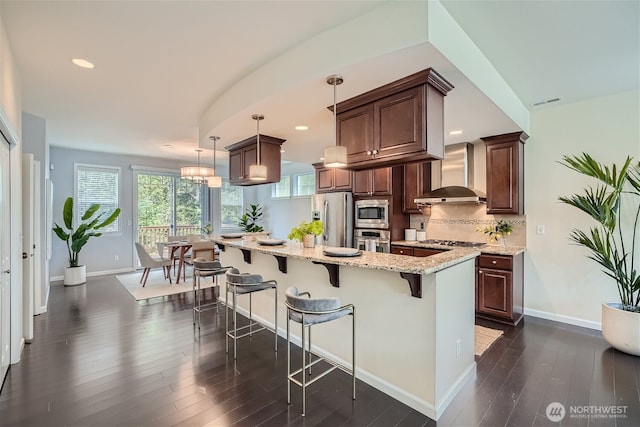 10502 SE 10th Ct Unit 9, Bellevue, WA 98004 - kitchen featuring wall chimney exhaust hood, appliances with stainless steel finishes, dark wood-style floors, baseboards, and recessed lighting