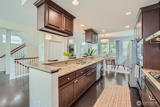10502 SE 10th Ct Unit 9, Bellevue, WA 98004 - kitchen featuring a sink, appliances with stainless steel finishes, dark wood-style floors, light stone counters, and baseboards