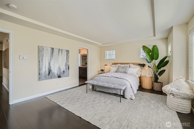10502 SE 10th Ct Unit 9, Bellevue, WA 98004 - bedroom featuring a tray ceiling, baseboards, wood finished floors, and ensuite bath