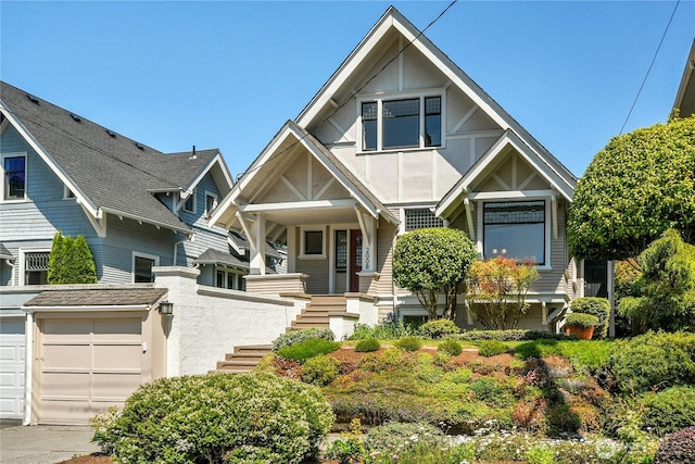 2008 Nob Hill Ave N, Seattle, WA 98119 - view of front facade featuring stairway, a porch, stucco siding, and a garage
