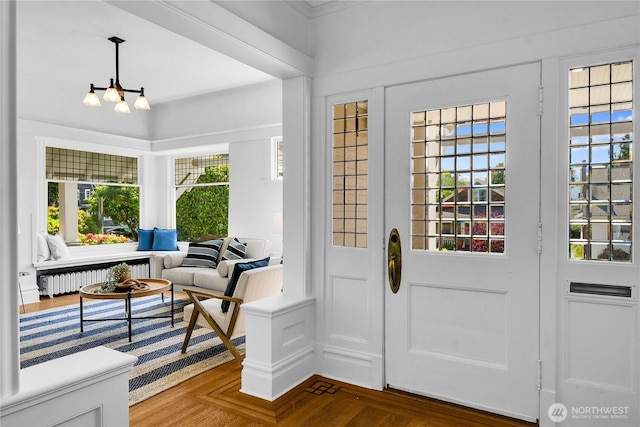 2008 Nob Hill Ave N, Seattle, WA 98119 - foyer entrance featuring radiator, a chandelier, and crown molding