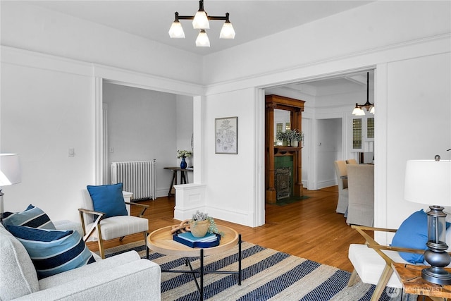 2008 Nob Hill Ave N, Seattle, WA 98119 - living area featuring radiator, light wood finished floors, and a chandelier