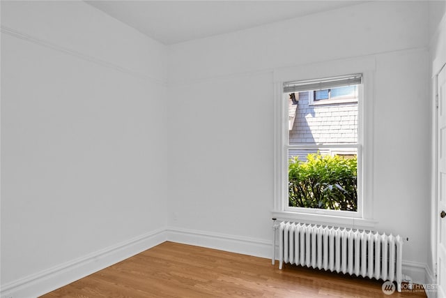 2008 Nob Hill Ave N, Seattle, WA 98119 - spare room featuring radiator heating unit, wood finished floors, and baseboards