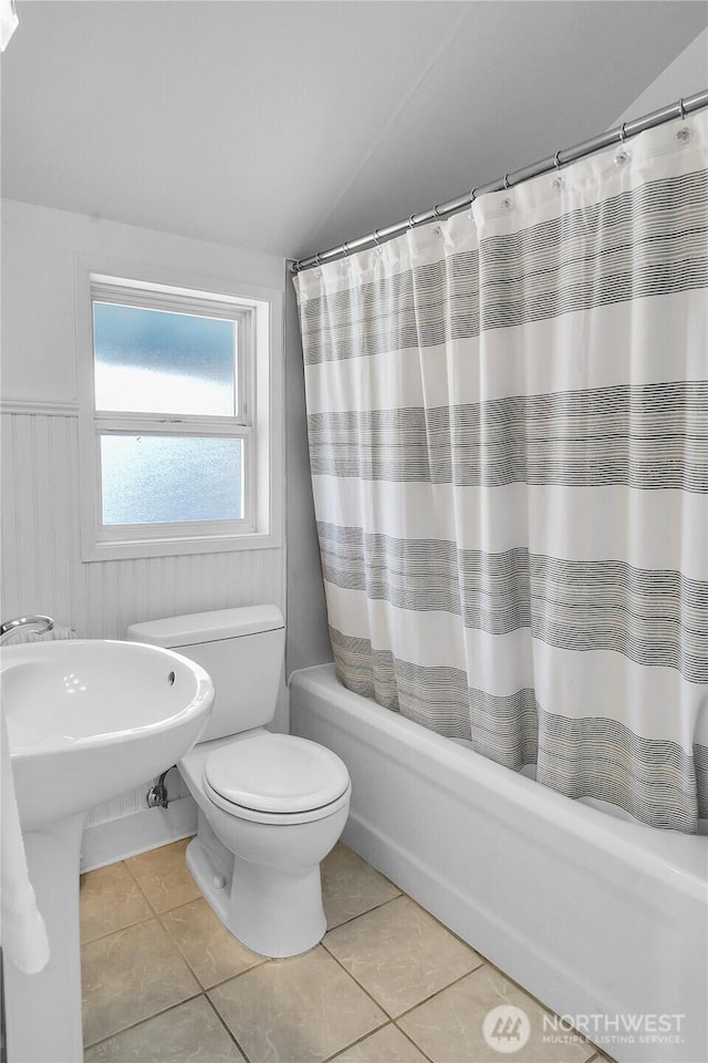 2008 Nob Hill Ave N, Seattle, WA 98119 - full bath featuring toilet, shower / tub combo, vaulted ceiling, tile patterned flooring, and wainscoting