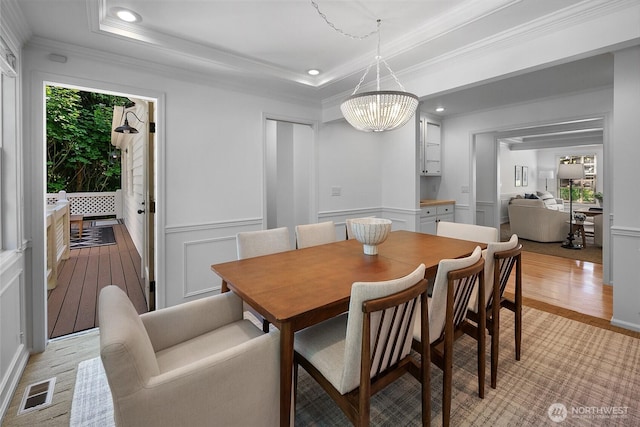2020 Evergreen Point Rd, Medina, WA 98039 - dining space featuring crown molding, healthy amount of natural light, a chandelier, a decorative wall, and light wood finished floors