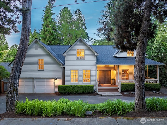 2020 Evergreen Point Rd, Medina, WA 98039 - view of front of house with roof with shingles, asphalt driveway, and a garage