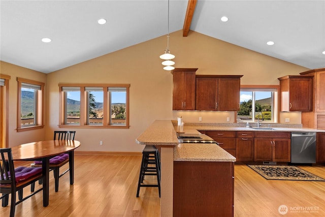 4261 April Dr, Wenatchee, WA 98801 - kitchen featuring stainless steel dishwasher, a sink, a kitchen breakfast bar, a peninsula, and brown cabinets