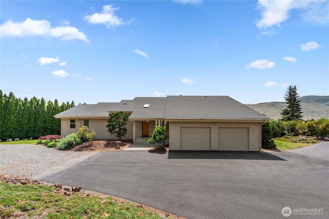 4261 April Dr, Wenatchee, WA 98801 - view of front facade with a mountain view, an attached garage, and asphalt driveway