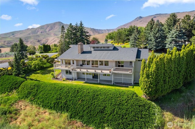 4261 April Dr, Wenatchee, WA 98801 - back of house with a chimney, stairs, and a deck with mountain view