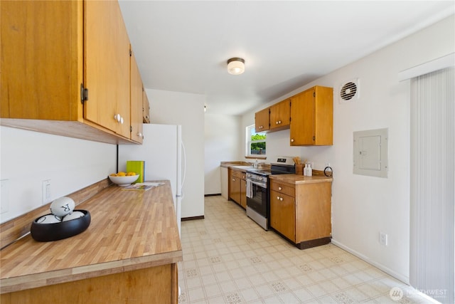 3309 W 2nd St, Anacortes, WA 98221 - kitchen featuring stainless steel electric range, electric panel, light floors, light countertops, and freestanding refrigerator