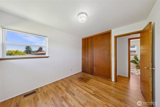 3309 W 2nd St, Anacortes, WA 98221 - unfurnished bedroom featuring light wood-type flooring, a closet, and baseboards
