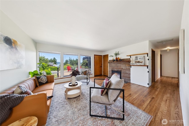 3309 W 2nd St, Anacortes, WA 98221 - living room featuring a warm lit fireplace and wood finished floors