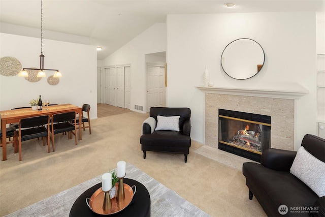 3673 224th Pl SE Unit 1349, Issaquah, WA 98029 - living area featuring carpet, a chandelier, vaulted ceiling, and a high end fireplace