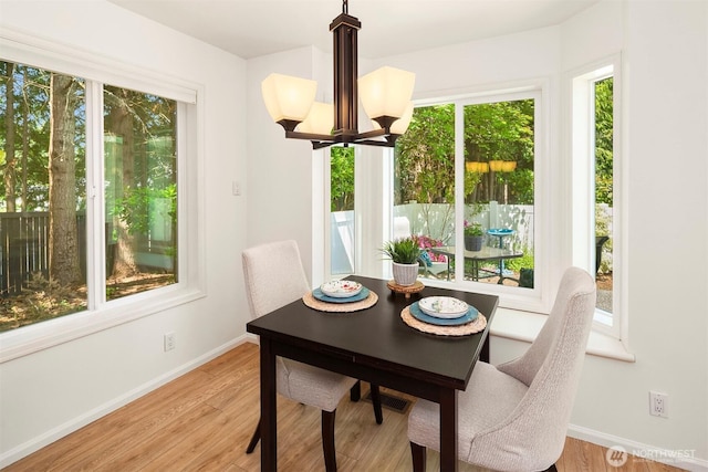 3673 224th Pl SE Unit 1349, Issaquah, WA 98029 - dining space featuring baseboards, a chandelier, and light wood-style flooring