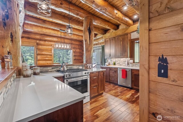 158 Big Pine Dr, Leavenworth, WA 98826 - kitchen featuring appliances with stainless steel finishes, wooden ceiling with exposed beams, light wood-style flooring, light countertops, and tasteful backsplash