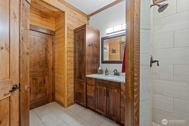 158 Big Pine Dr, Leavenworth, WA 98826 - bathroom with wood walls, vanity, a tile shower, and tile patterned floors