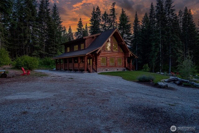 158 Big Pine Dr, Leavenworth, WA 98826 - log-style house with log exterior, crawl space, covered porch, gravel driveway, and a wooded view