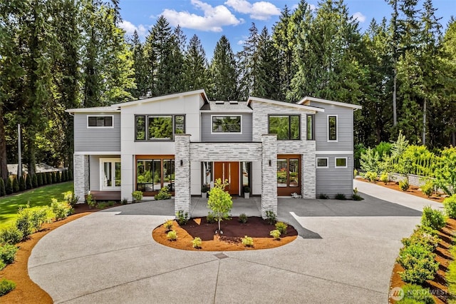 23036 35th Ave SE, Bothell, WA 98021 - contemporary home with stone siding, curved driveway, french doors, and a patio