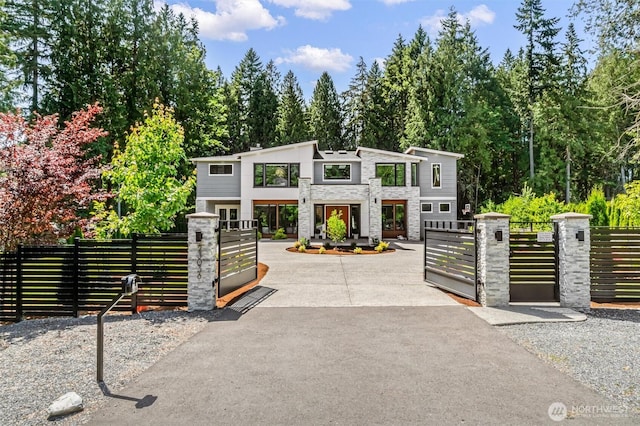 23036 35th Ave SE, Bothell, WA 98021 - contemporary home with a gate, stone siding, and a fenced front yard