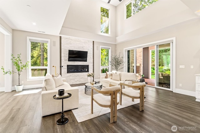 23036 35th Ave SE, Bothell, WA 98021 - living area with plenty of natural light, baseboards, dark wood finished floors, a glass covered fireplace, and a high ceiling
