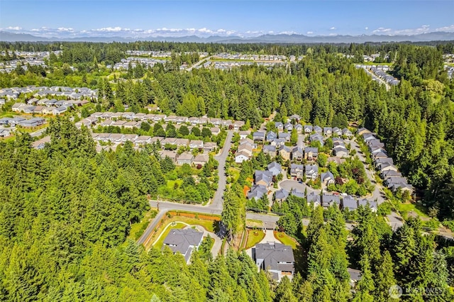 23036 35th Ave SE, Bothell, WA 98021 - aerial perspective of suburban area featuring a heavily wooded area and a mountain backdrop