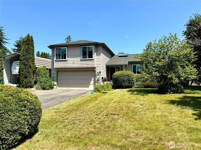 1711 Mount Rainier Blvd, Spanaway, WA 98387 - split level home featuring asphalt driveway, a garage, a front lawn, and roof with shingles