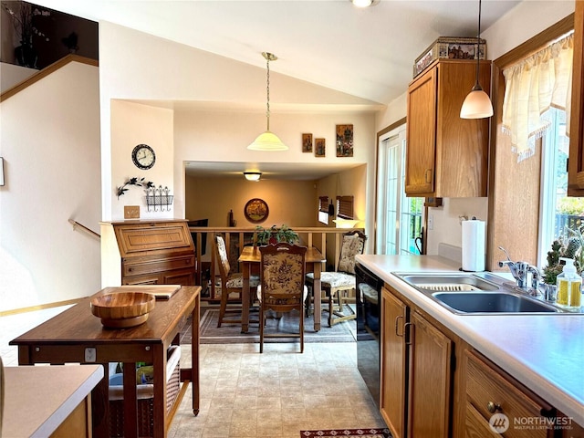 1711 Mount Rainier Blvd, Spanaway, WA 98387 - kitchen featuring a sink, vaulted ceiling, brown cabinetry, light countertops, and hanging light fixtures
