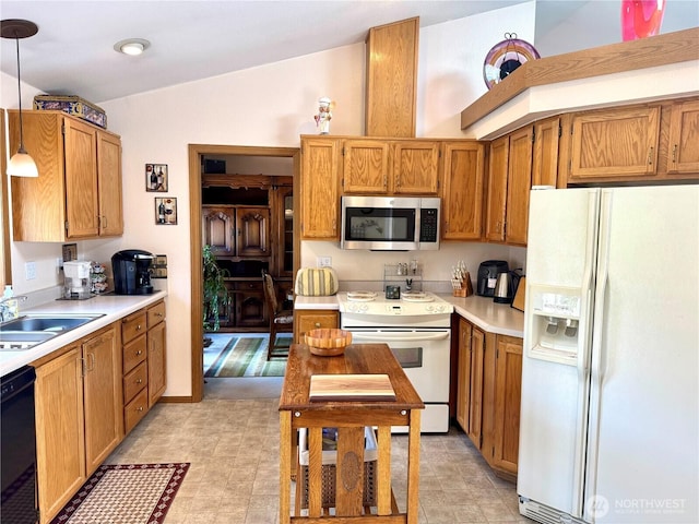 1711 Mount Rainier Blvd, Spanaway, WA 98387 - kitchen featuring white appliances, a sink, light countertops, brown cabinetry, and hanging light fixtures