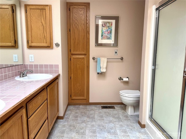 1711 Mount Rainier Blvd, Spanaway, WA 98387 - full bath with a stall shower, double vanity, backsplash, baseboards, and toilet