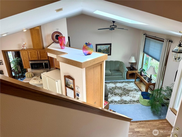 1711 Mount Rainier Blvd, Spanaway, WA 98387 - living area with lofted ceiling, a skylight, light wood-style floors, plenty of natural light, and a ceiling fan