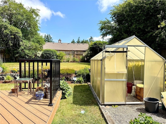 1711 Mount Rainier Blvd, Spanaway, WA 98387 - view of yard featuring a greenhouse, an outbuilding, and a deck