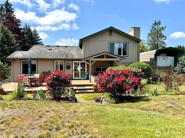 1711 Mount Rainier Blvd, Spanaway, WA 98387 - back of house with a chimney, a wooden deck, a lawn, and a carport
