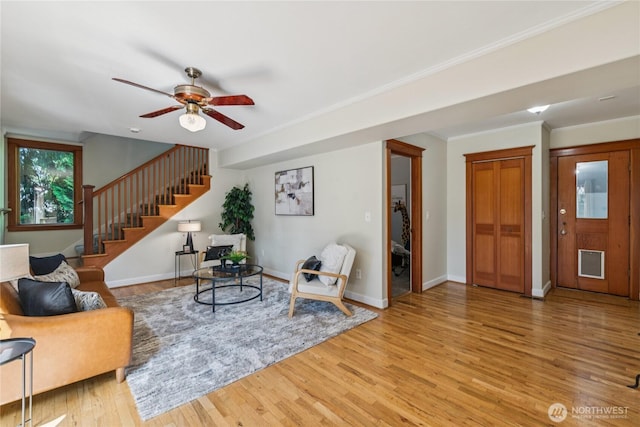13257 4th Ave S, Burien, WA 98168 - living room with light wood-style floors, stairway, a ceiling fan, baseboards, and ornamental molding