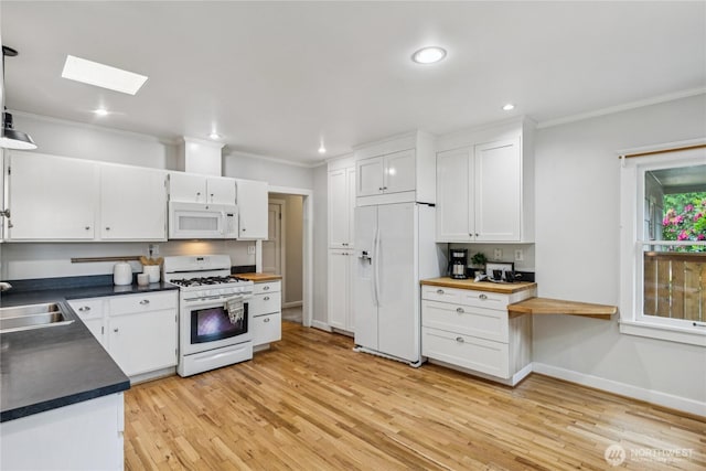 13257 4th Ave S, Burien, WA 98168 - kitchen with white appliances, white cabinets, ornamental molding, light wood-style floors, and baseboards