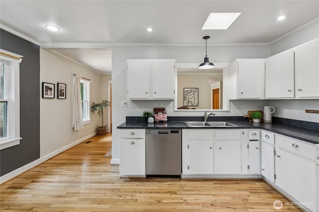 13257 4th Ave S, Burien, WA 98168 - kitchen featuring stainless steel dishwasher, a sink, dark countertops, a skylight, and white cabinets