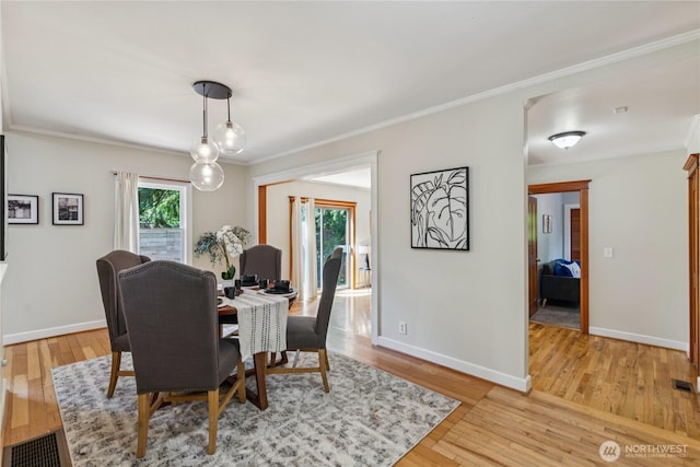 13257 4th Ave S, Burien, WA 98168 - dining area featuring light wood-style flooring, baseboards, and ornamental molding